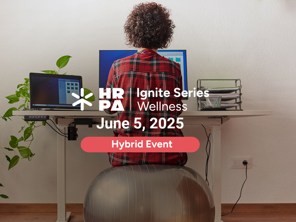 A HR professional working at a desk.